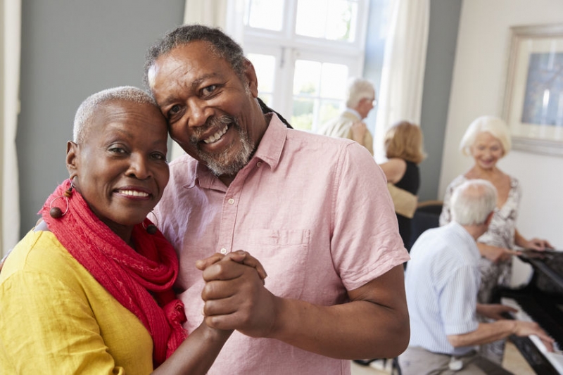 senior couple dancing with piano in background