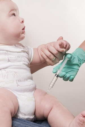 Baby receiving his scheduled vaccine injection