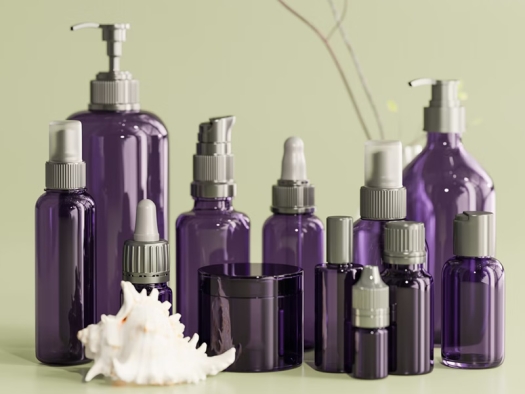 Purple bottles for cosmetics and lotions with a white conch shell in the forground
