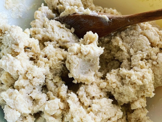 dough in bowl with wooden spoon