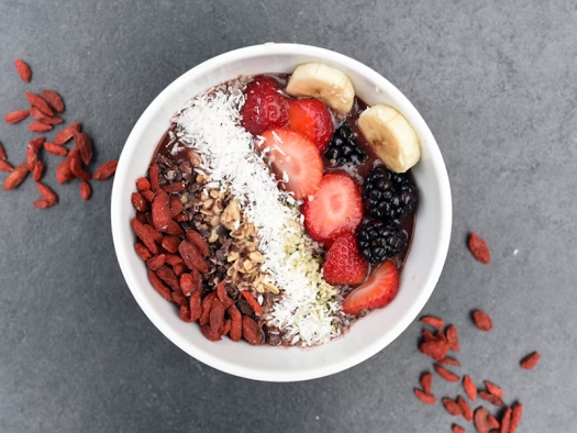 Nuts and berries in a white bowl.