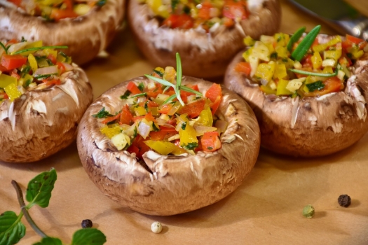 small mushroom caps stuffed with colorful peppers and herbs