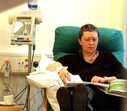 woman in chair receiving IV therapy