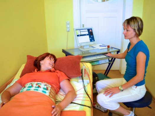 patient lying on table receiving treatment with medical staff nearby