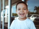 young boy in white Tshirt  laughing