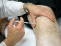Man getting injection in knee