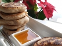 stack of pancakes and dish of maple syrup