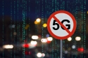 Sign shows "no 5G" with a city street at night data matrix in background