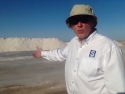 Robert Cain in front of large piles of sea salt