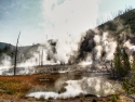 bubbling mud pots with rising steam and gasses in Yellowstone