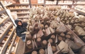 Person surrounded by bags and jars of seeds at the Seed Savers Exchange.